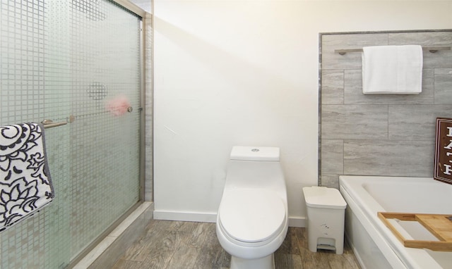 1022 Kintner Dr, Graham, TX 76450 - full bath featuring wood finished floors, toilet, tiled shower, a tub, and baseboards