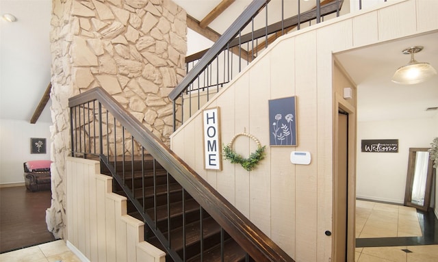 1022 Kintner Dr, Graham, TX 76450 - stairs featuring tile patterned floors, beamed ceiling, and baseboards