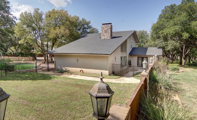 1022 Kintner Dr, Graham, TX 76450 - rear view of house with a chimney, brick siding, and roof with shingles