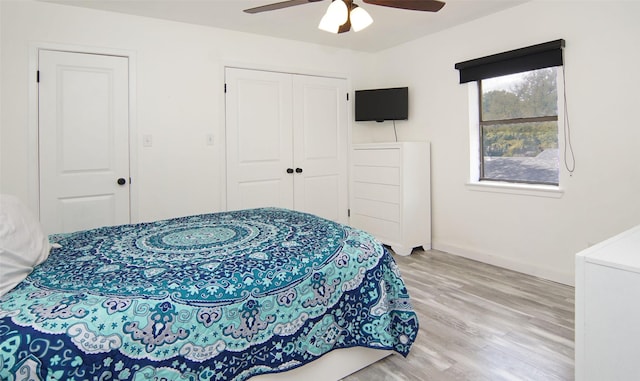 1022 Kintner Dr, Graham, TX 76450 - bedroom with light wood-style floors, a closet, baseboards, and ceiling fan