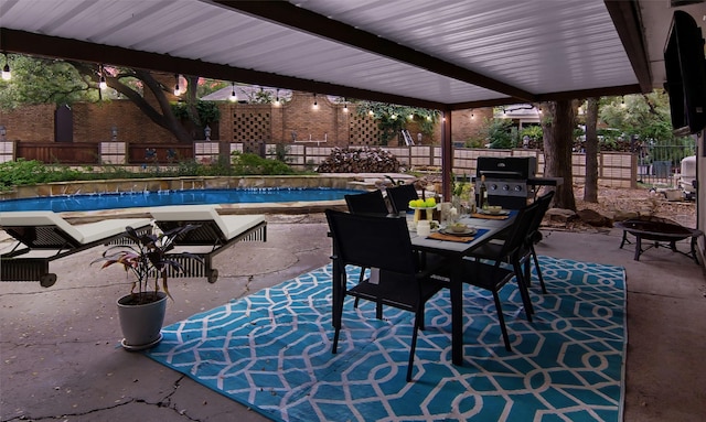 1022 Kintner Dr, Graham, TX 76450 - view of patio featuring a fenced backyard, grilling area, outdoor dining space, and an outdoor fire pit