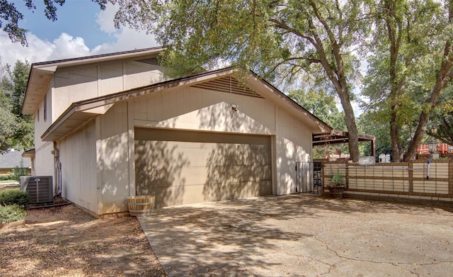 1022 Kintner Dr, Graham, TX 76450 - garage featuring concrete driveway, central AC unit, and fence