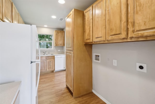 12824 Seagoville Rd, Balch Springs, TX 75180 - laundry area featuring hookup for an electric dryer, a sink, light wood-style floors, recessed lighting, and hookup for a washing machine