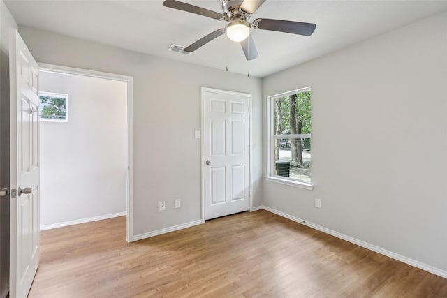 12824 Seagoville Rd, Balch Springs, TX 75180 - unfurnished bedroom featuring light wood-style floors, baseboards, and ceiling fan