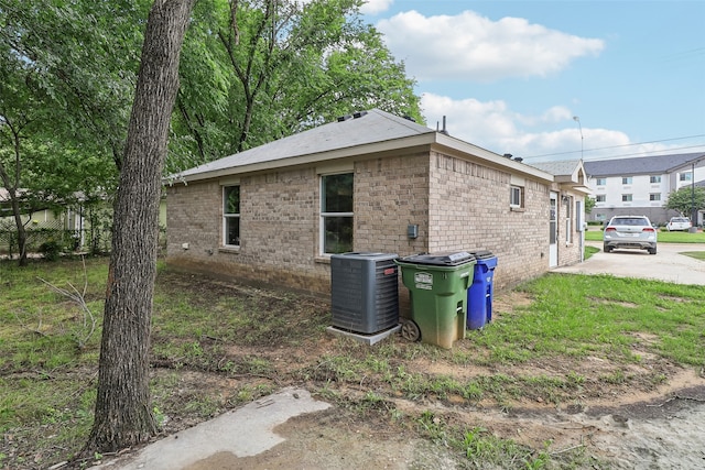 12824 Seagoville Rd, Balch Springs, TX 75180 - view of property exterior featuring central AC and brick siding