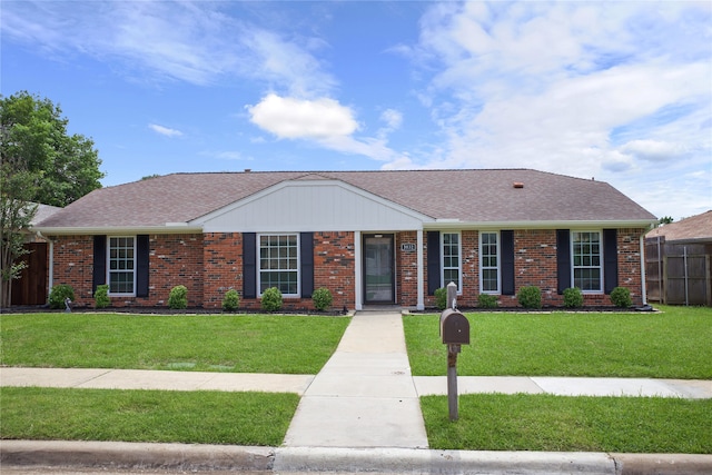 view of front of property featuring roof with shingles and brick siding