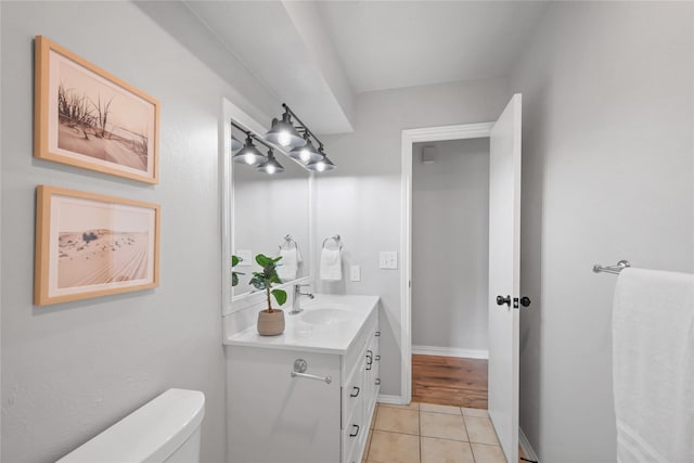 bathroom with toilet, tile patterned floors, and vanity