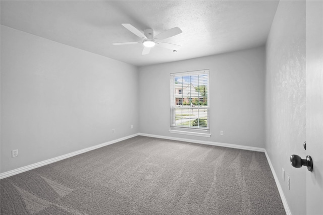 spare room featuring carpet flooring, a ceiling fan, and baseboards