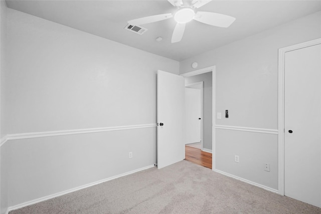 unfurnished bedroom featuring carpet floors, a ceiling fan, and baseboards