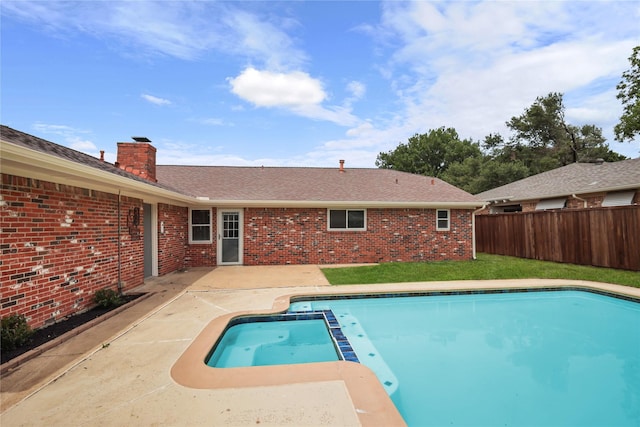 view of swimming pool featuring a fenced backyard, a patio area, and a pool with connected hot tub