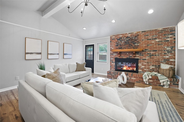 living room featuring wood finished floors, a chandelier, a brick fireplace, baseboards, and recessed lighting