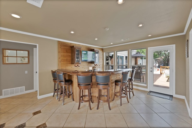 1503 Hindsdale Dr, Richardson, TX 75081 - kitchen featuring ornamental molding, glass insert cabinets, a breakfast bar, recessed lighting, and a peninsula