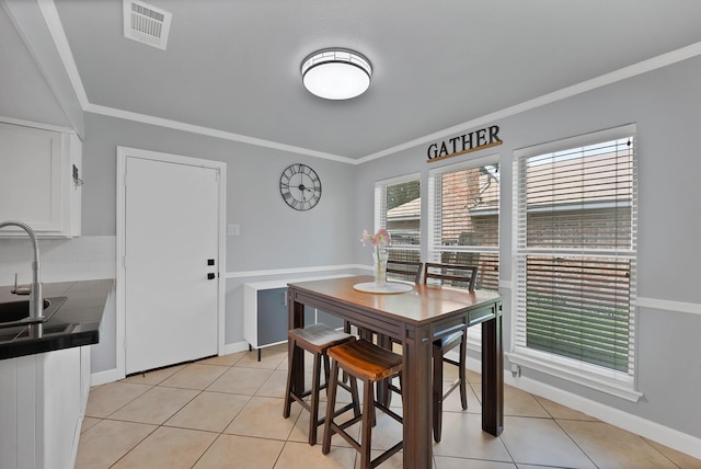 1503 Hindsdale Dr, Richardson, TX 75081 - dining area featuring crown molding, light tile patterned floors, and baseboards