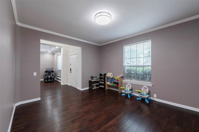 recreation room with wood finished floors, crown molding, and baseboards