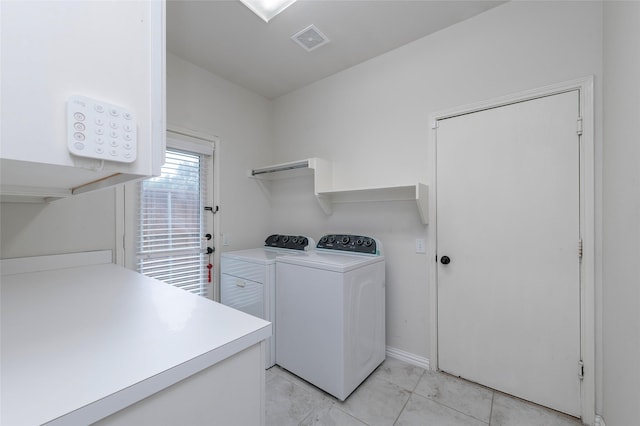 laundry area featuring washer and clothes dryer and light marble finish flooring