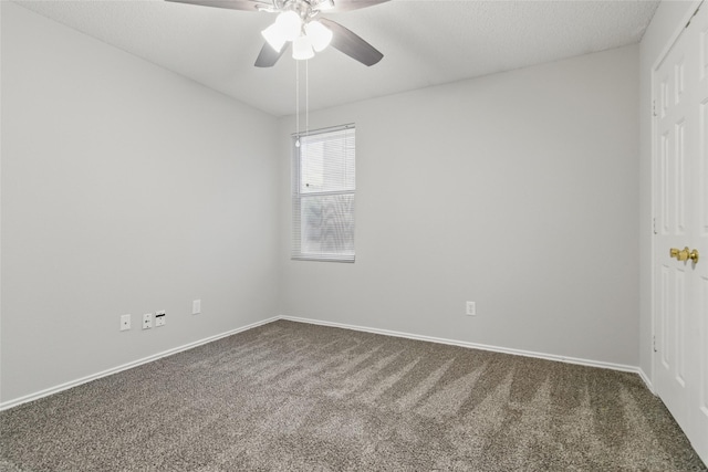 spare room with carpet floors, ceiling fan, and baseboards
