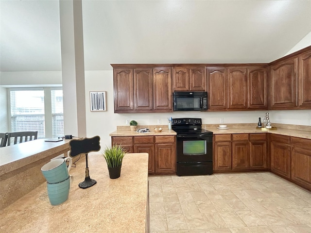2041 Matador Ranch Rd, Fort Worth, TX 76134 - kitchen featuring black appliances, lofted ceiling, and light countertops
