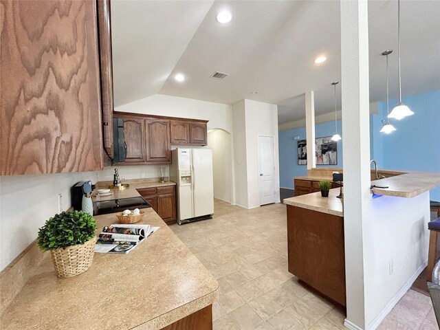 2041 Matador Ranch Rd, Fort Worth, TX 76134 - kitchen with white fridge with ice dispenser, light countertops, black microwave, decorative light fixtures, and recessed lighting