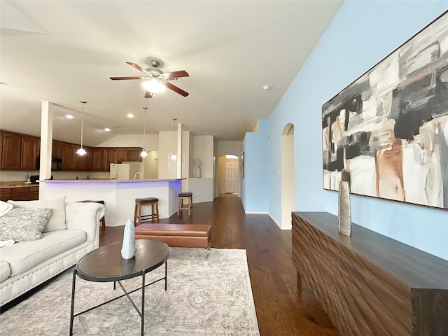 2041 Matador Ranch Rd, Fort Worth, TX 76134 - living room with a ceiling fan, lofted ceiling, dark wood-style flooring, and arched walkways