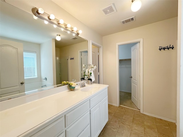 2041 Matador Ranch Rd, Fort Worth, TX 76134 - full bath featuring a stall shower, vanity, baseboards, and a walk in closet