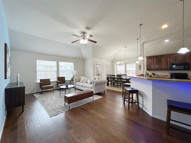 2041 Matador Ranch Rd, Fort Worth, TX 76134 - living room featuring dark wood finished floors, ceiling fan, a chandelier, lofted ceiling, and recessed lighting