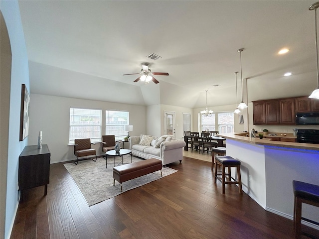2041 Matador Ranch Rd, Fort Worth, TX 76134 - living room featuring dark wood-type flooring, a ceiling fan, recessed lighting, a chandelier, and lofted ceiling