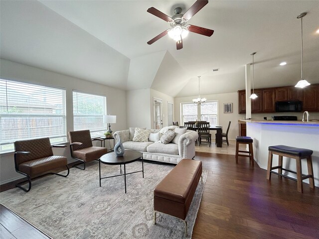 2041 Matador Ranch Rd, Fort Worth, TX 76134 - living area featuring dark wood-style flooring, ceiling fan, a chandelier, vaulted ceiling, and baseboards