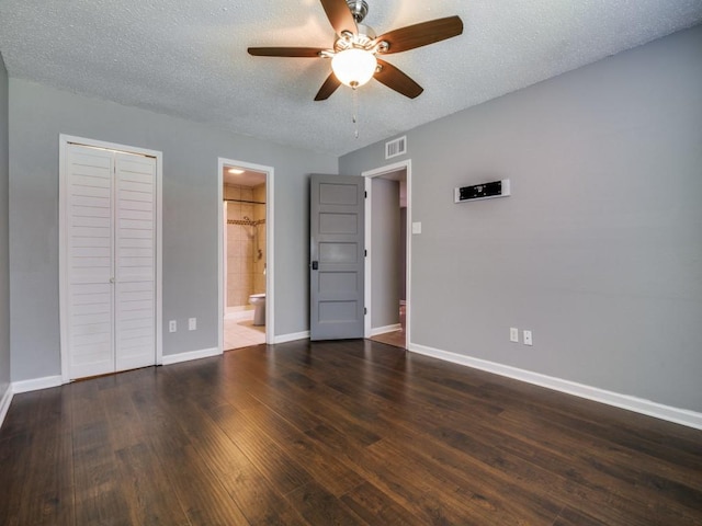 unfurnished bedroom with baseboards, dark wood-style flooring, a textured ceiling, a closet, and a ceiling fan