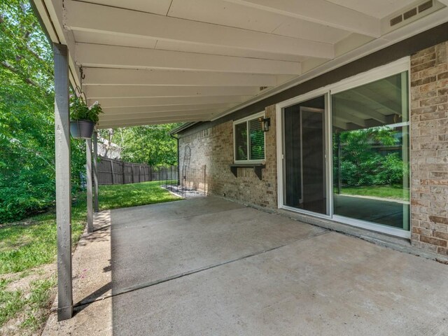 view of patio / terrace featuring fence