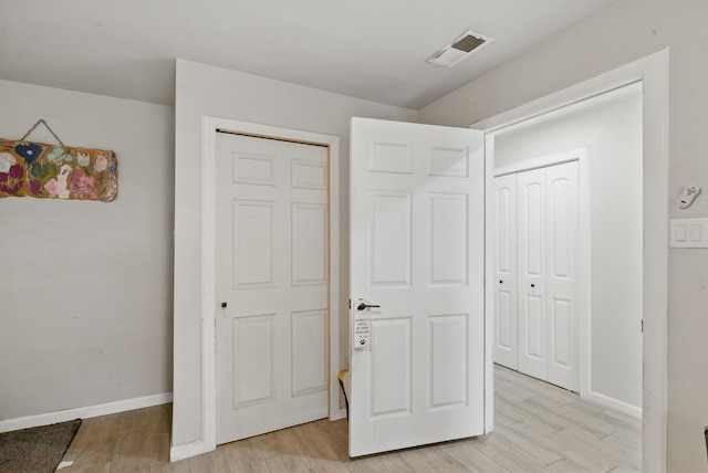 unfurnished bedroom featuring light wood-style flooring and baseboards