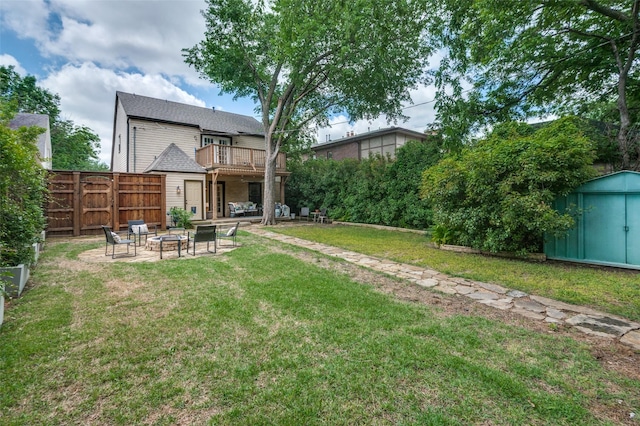 view of yard featuring a fire pit, a storage unit, a balcony, a patio area, and an outdoor structure