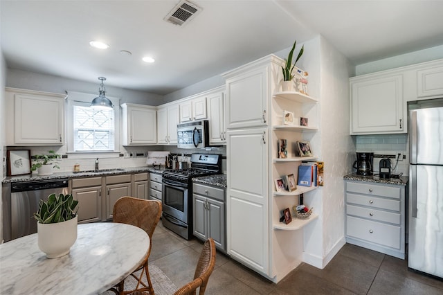 kitchen featuring stainless steel appliances, a sink, open shelves, decorative backsplash, and recessed lighting