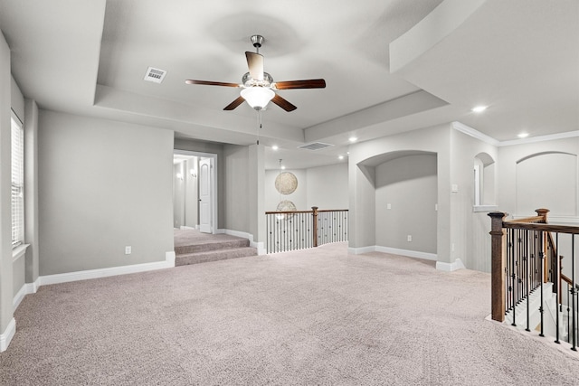 carpeted empty room with ceiling fan, a tray ceiling, recessed lighting, and baseboards