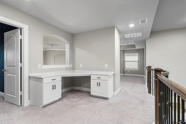 unfurnished office featuring light carpet, baseboards, built in study area, and recessed lighting