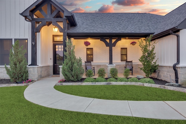 109 Highland Ranch Dr, Paradise, TX 76073 - view of front of home with a shingled roof, a yard, board and batten siding, and covered porch