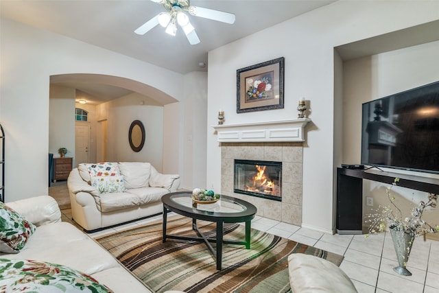 14117 Golden Pass Rd, Balch Springs, TX 75181 - tiled living area featuring arched walkways, ceiling fan, and a fireplace