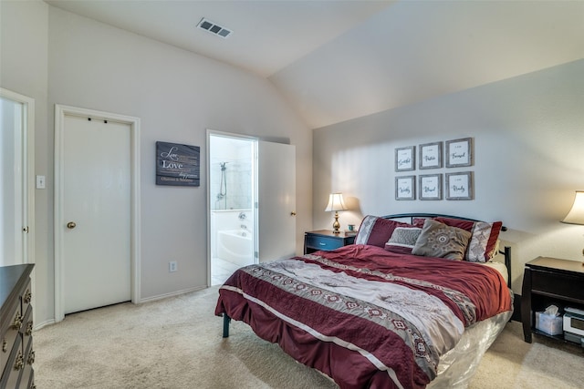 carpeted bedroom featuring lofted ceiling, baseboards, and ensuite bathroom