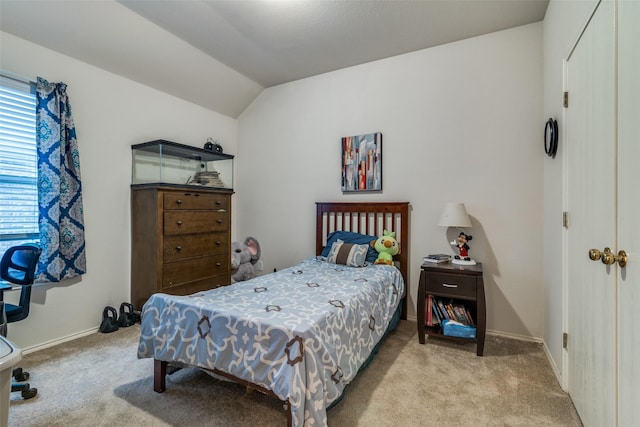 carpeted bedroom with vaulted ceiling and baseboards