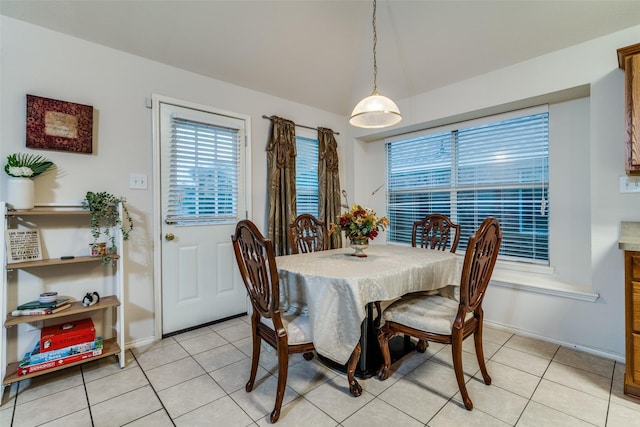 dining space with light tile patterned flooring and baseboards