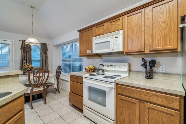 kitchen featuring white appliances, lofted ceiling, light countertops, pendant lighting, and light tile patterned flooring
