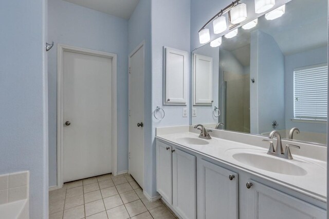 full bath featuring tile patterned flooring, double vanity, a shower, a bathtub, and baseboards