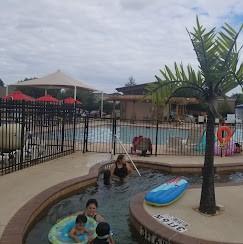 view of swimming pool featuring fence