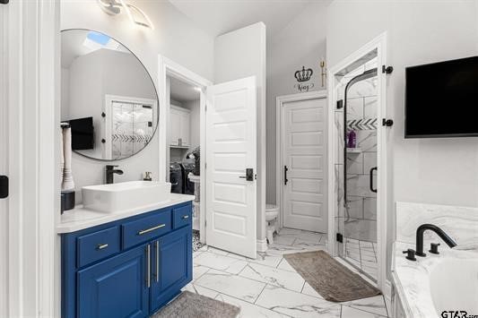 2230 Rana Park, Flint, TX 75762 - bathroom featuring marble look tile flooring, a garden tub, toilet, a stall shower, and vanity