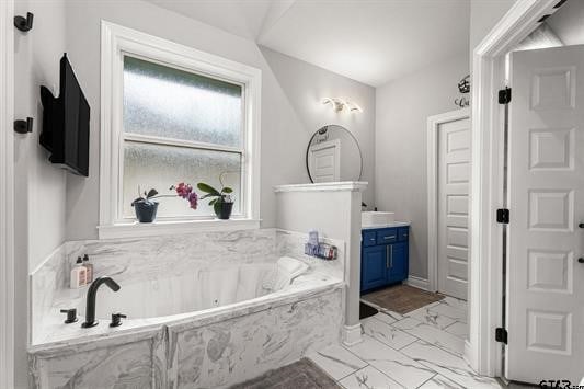 2230 Rana Park, Flint, TX 75762 - bathroom featuring marble look tile flooring, vanity, and a garden tub