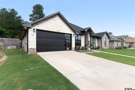 2230 Rana Park, Flint, TX 75762 - view of front facade featuring an attached garage, concrete driveway, brick siding, and stone siding