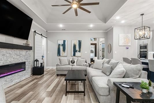 2230 Rana Park, Flint, TX 75762 - living area with a tray ceiling, a barn door, ceiling fan, light wood-type flooring, and recessed lighting