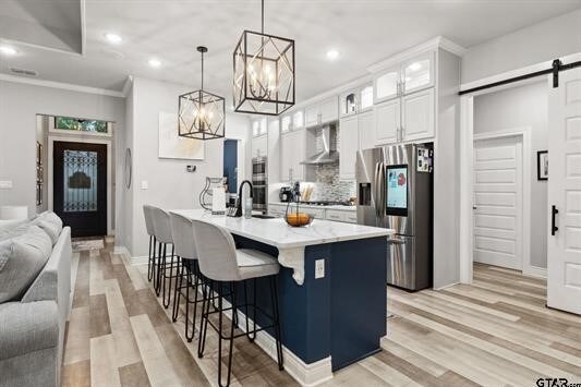 2230 Rana Park, Flint, TX 75762 - kitchen featuring stainless steel fridge, a barn door, wall chimney range hood, light wood finished floors, and recessed lighting