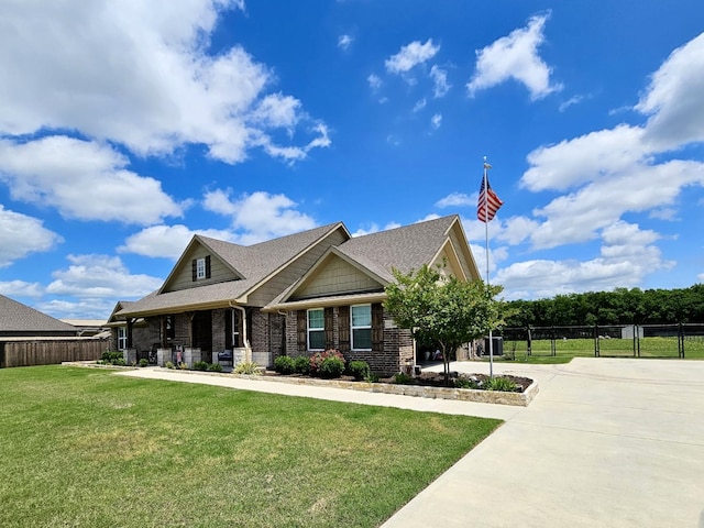 craftsman-style house featuring brick siding, roof with shingles, and concrete driveway