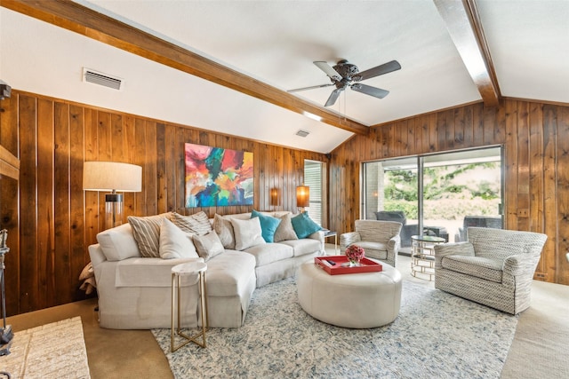 living area featuring wood walls, a ceiling fan, and carpet floors