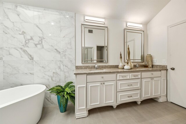 bathroom featuring a soaking tub and double vanity